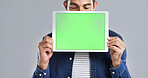 Man, hands and tablet with green screen for advertising, presentation or show on a white background. Male person, model or marketing with technology display or chromakey for app on mockup space