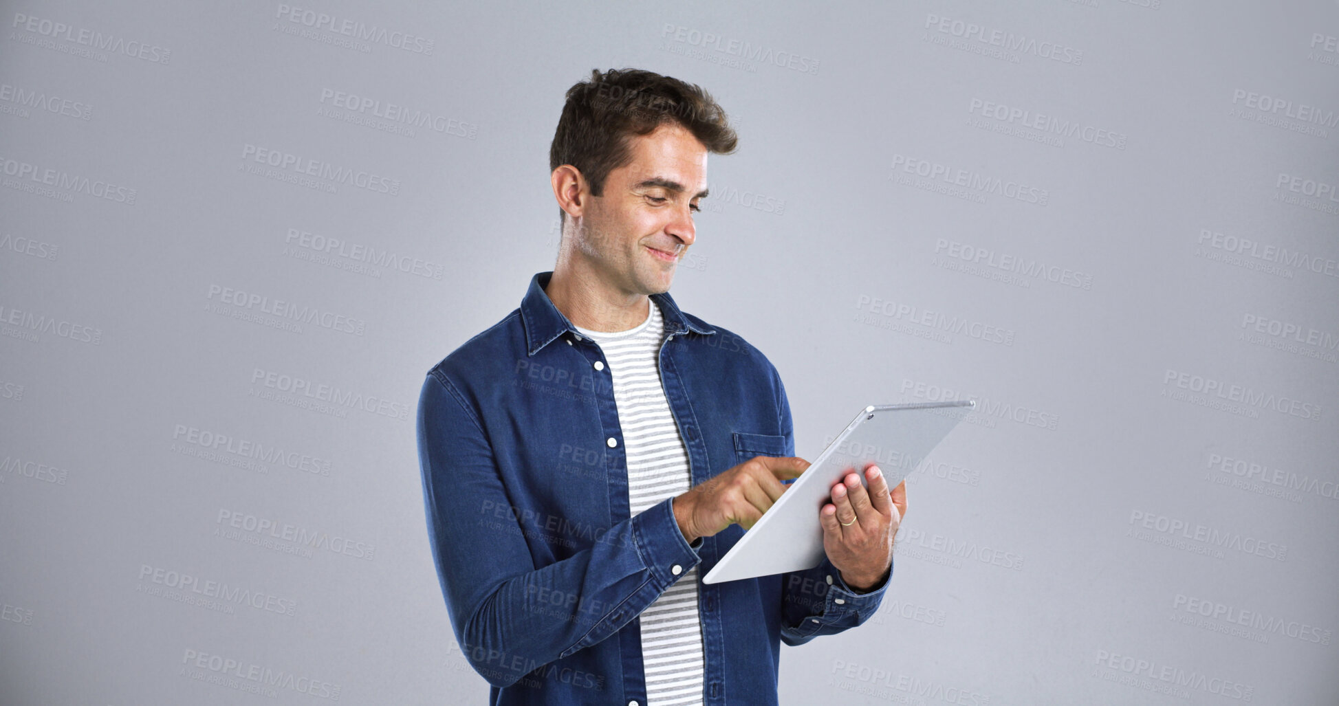 Buy stock photo Smile, tablet and website with man in studio for programming or software development career. App, mainframe and system maintenance with tech guru on white background space for professional IT support