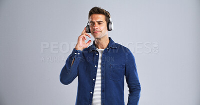 Buy stock photo Man, listening and music with headphones in studio for streaming podcast, morning radio and playlist. Mockup space, male person and tech for hearing song, groovy audio and album on white background