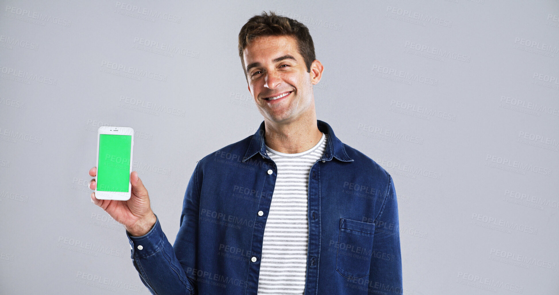 Buy stock photo Happy man, portrait and phone with green screen for advertising in studio on a white background. Male person, model or smile with mobile smartphone display or chromakey for marketing on mockup space