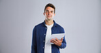 Creative man, designer and portrait with tablet in studio for web design on a white background. Male person, model or digital artist with smile or technology for software, app or development on space