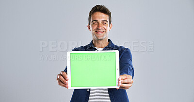 Buy stock photo Happy man, tablet or advertising with green screen in studio for marketing on a white background. Male person, model or showing with smile, technology display or chromakey for new app on mockup space