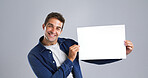 Portrait, man and blank paper in studio for billboard poster, branding flyer and announcement. Smile, mockup space and show signage with person, information and message notice on white background