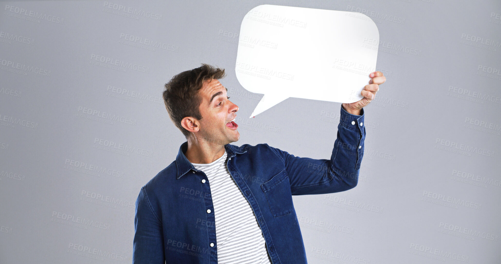 Buy stock photo Talking, happy man and speech bubble in studio for communication forum, social media and feedback. Chat, person and dialogue balloon for opinion, quote and FAQ on white background with mockup space