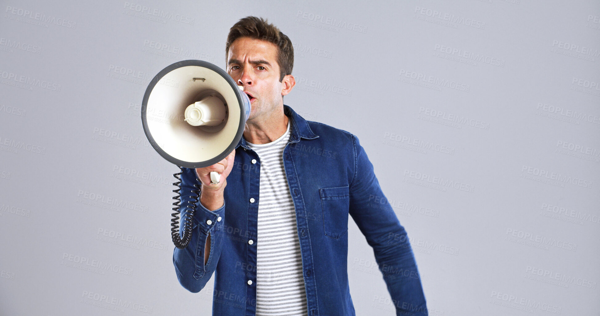 Buy stock photo Portrait, bullhorn and man in studio, shouting or angry with protest on white background. Expression, person or model with megaphone, frustrated or activism for human rights, voice or social justice