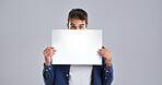 Man, portrait and blank poster with billboard in studio for advertising on a white background. Male person, model or holding sign with notification for message, alert or marketing on mockup space