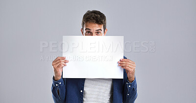 Buy stock photo Man, portrait and blank poster with billboard in studio for advertising on white background. Male person, model or holding sign with notification for message, alert or marketing on mockup space