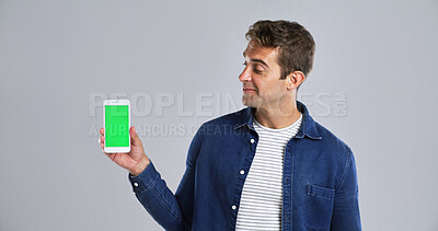 Buy stock photo Man, advertising or phone with green screen in studio for new app on a white background. Male person, model or user with mobile smartphone display, chromakey or UX for marketing or UI on mockup space