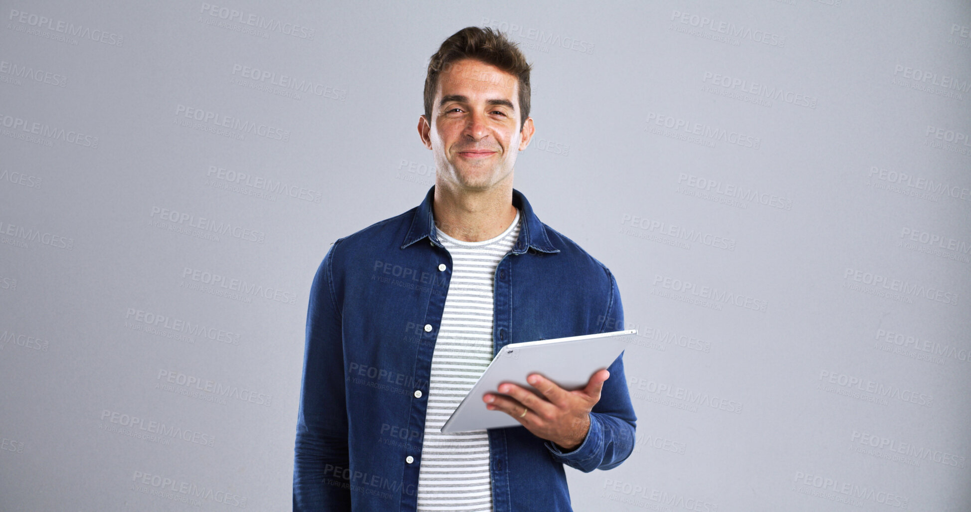 Buy stock photo Portrait, smile and tablet with editor man in studio for proofreading article of online magazine. App, column and post editing with happy freelance journalist on white background space for publishing