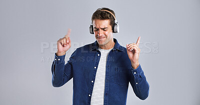 Buy stock photo Music, headphones and man with dance for fun, online streaming or radio with mockup space in studio. Energy, listening with audio tech and sound for rhythm with male person on white background