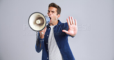 Buy stock photo Portrait, bullhorn or man in studio, angry or social justice with protest on white background. Announcement, voice or person with megaphone, politics or activism for human rights or gesture for stop