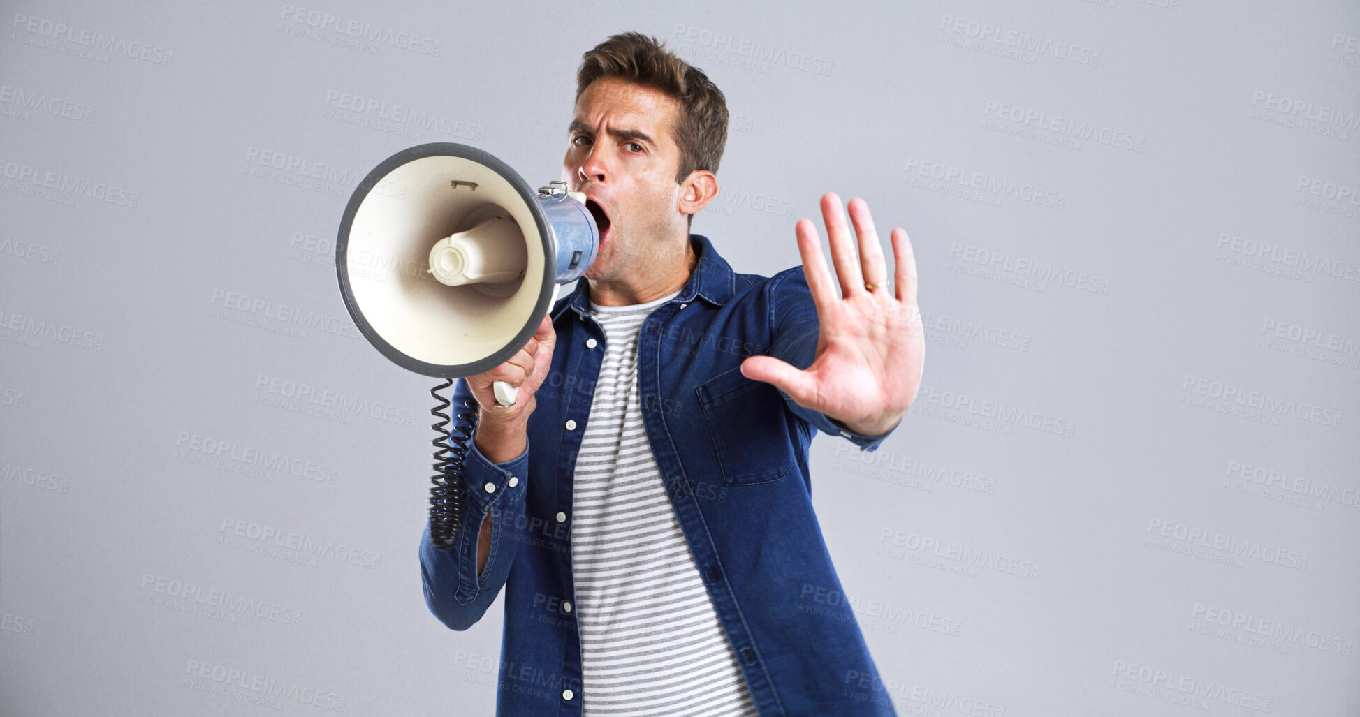 Buy stock photo Portrait, bullhorn or man in studio, angry or social justice with protest on white background. Announcement, voice or person with megaphone, politics or activism for human rights or gesture for stop