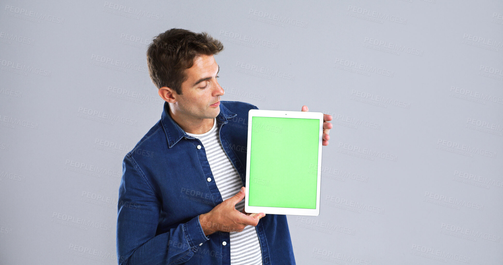 Buy stock photo Man, tablet screen or chromakey in studio for advertising or presentation on white background. Male person, model or user with green technology display for UI, UX or marketing on mockup space