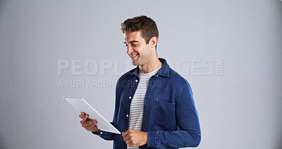 Buy stock photo Happy, funny and man in studio, tablet and website information on white background. Mockup space, model or person with smile, technology or digital app for online humor or video with joke or internet