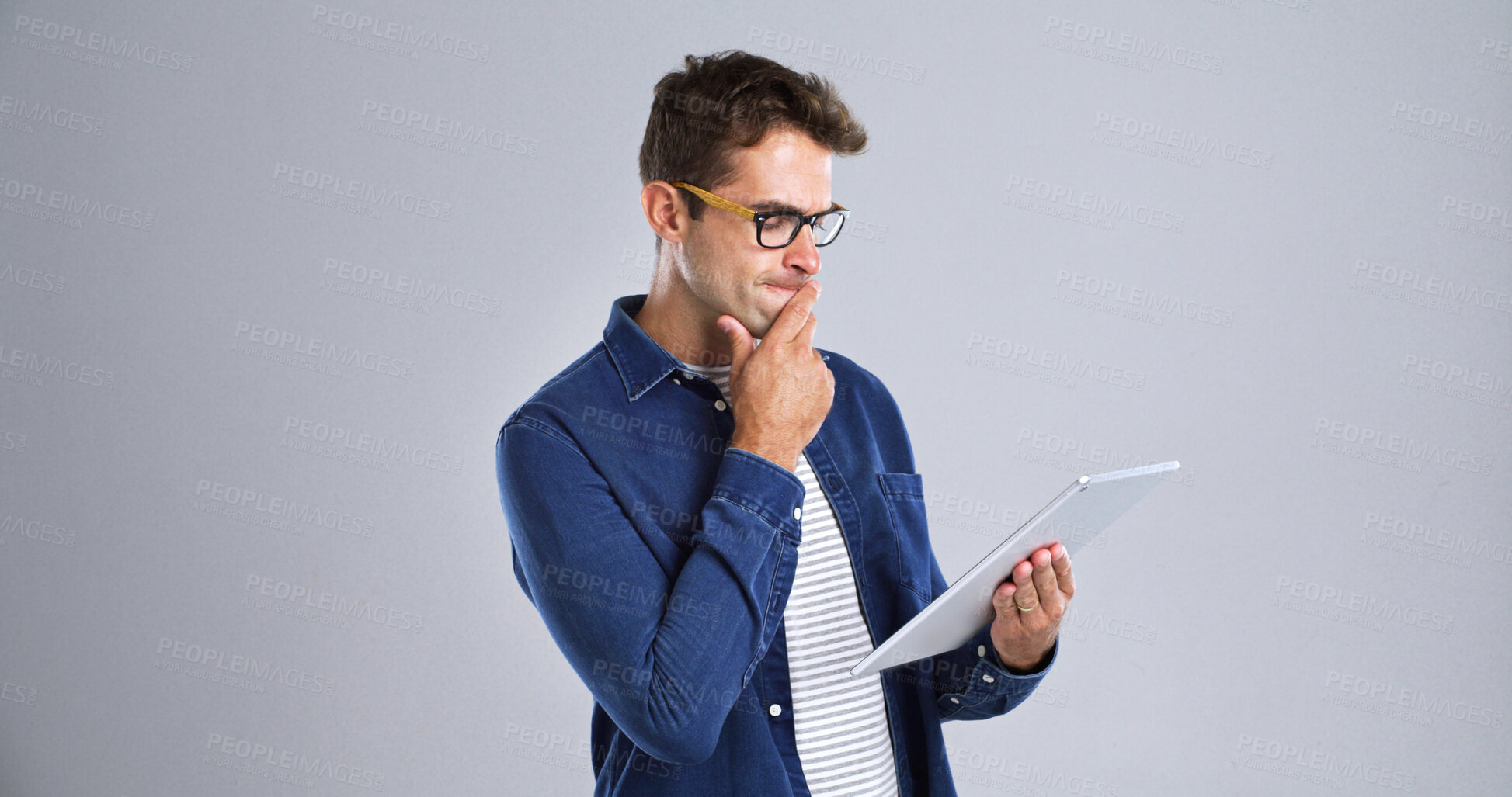 Buy stock photo Programmer, tablet or man with thinking in studio for software glitch, planning or troubleshooting. Mockup, web developer and confused with coding mistake, system solution or test on white background