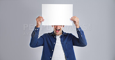 Buy stock photo Smile, man and poster with paper in studio for advertising, branding news and sale announcement. Mockup space, person and surprise with placard, message and information for launch on white background