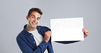 Buy stock photo Portrait, man and poster paper in studio of billboard news, branding flyer and announcement. Smile, mockup space and show signage with person, promo information and message notice on white background