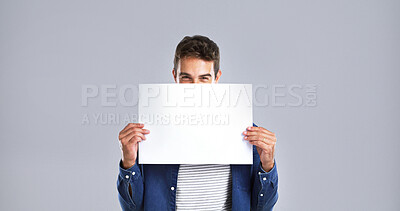 Buy stock photo Portrait, man and flyer paper in studio of billboard news, branding poster and announcement. Smile, mockup space and show signage with person, promo information and message notice on white background