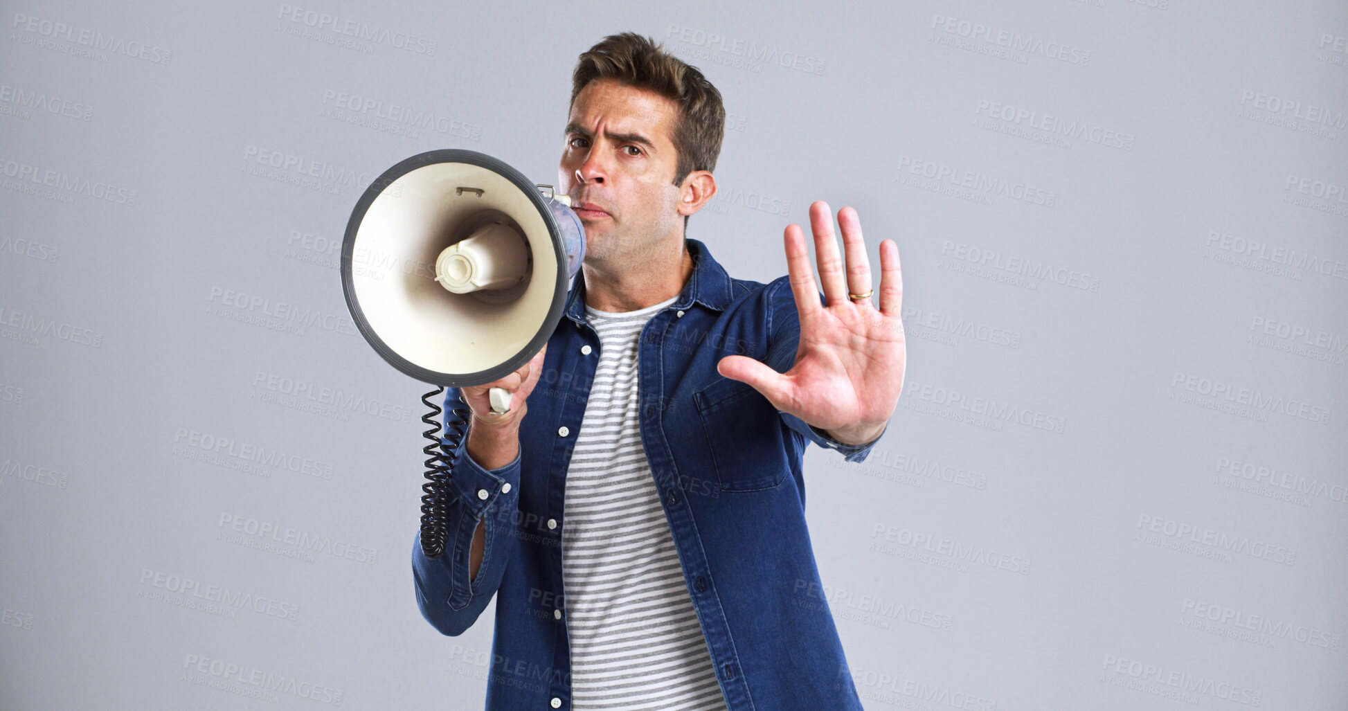 Buy stock photo Portrait, bullhorn and man with stop, angry or frustrated with protest on white studio background. Hand gesture, person or model with megaphone, social justice or activism for human rights or freedom