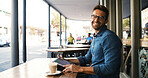 Laptop, portrait and remote work with man in cafe to research for small business startup. Computer, smile and website with freelance employee in booth of coffee shop or restaurant as customer