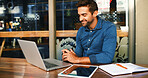 Smile, man and cafe with laptop at night for research, proofreading article and information. Journalist, online and reading email for story feedback, review newsletter and publishing for working late