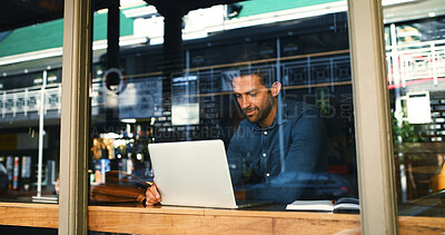 Buy stock photo Coffee shop, laptop and man by window for typing report, proposal and research for remote work. Restaurant, website and person on computer for internet, online project and review for freelance career