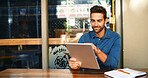 Cafe, man and editing on tablet for remote work, article information or online blog for publication. Coffee shop, male person and content writer with digital for freelancer, newsletter and reading