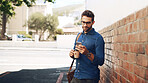Creative, man or texting with phone in city for travel, trip schedule or waiting on ride at bus stop. Professional, person or commute with smartphone on sidewalk for social media scroll or networking