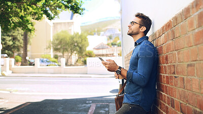 Buy stock photo Creative man, thinking and phone in city for travel, networking and taxi app for ride booking. Professional, person and commute with smartphone outdoor for text notification or social media scroll