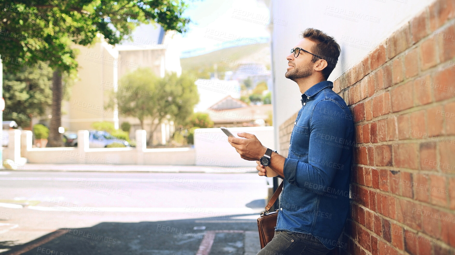 Buy stock photo Creative man, thinking and phone in city for travel, networking and taxi app for ride booking. Professional, person and commute with smartphone outdoor for text notification or social media scroll