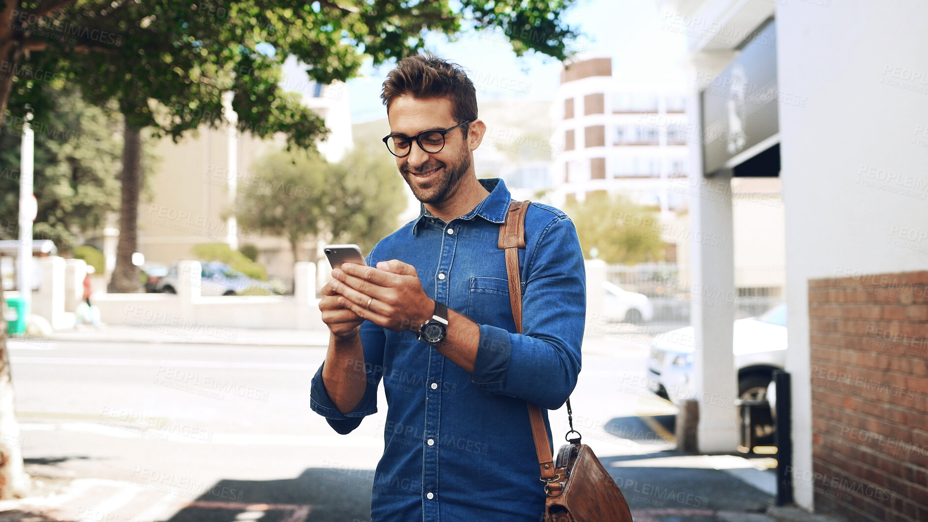 Buy stock photo Creative man, smile and phone in city for travel, networking and taxi app for ride booking. Happy professional, person and commute with smartphone outdoor for text notification or social media scroll