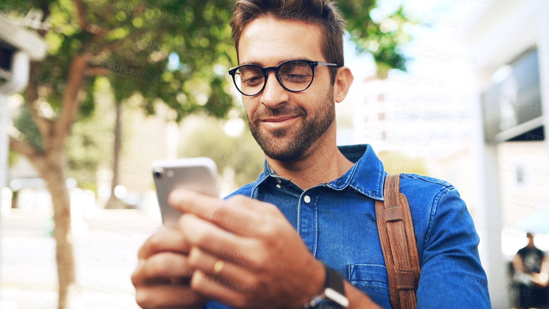 Buy stock photo Creative man, reading and phone in city for travel, networking and taxi app for ride booking. Happy professional, person and commute with smartphone for text notification or social media scroll