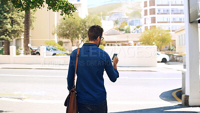 Buy stock photo Phone, walking and back of man in city with mobile app for maps with commuting to work in morning. Technology, bag and male journalist with cellphone for directions with travel in urban town.