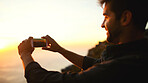 Man, hands and phone camera with sunset for picture, photography or capture moment in nature. Male person, hiker or travel with mobile smartphone or app for scenic view or memory of outdoor adventure