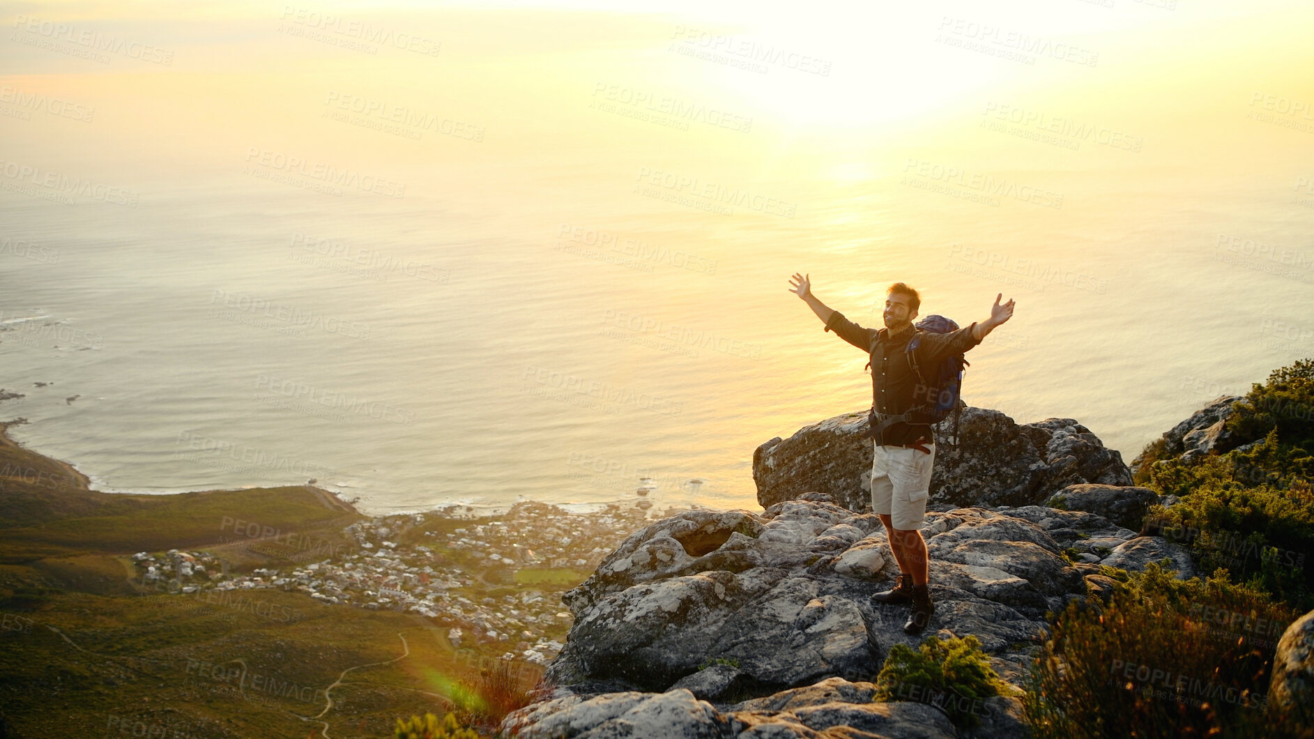 Buy stock photo Ocean, mountains and man with open arms, energy and excited with fitness, water and nature. Environment, hiker and person with happiness, exercise and seaside with weekend break, hobby or achievement