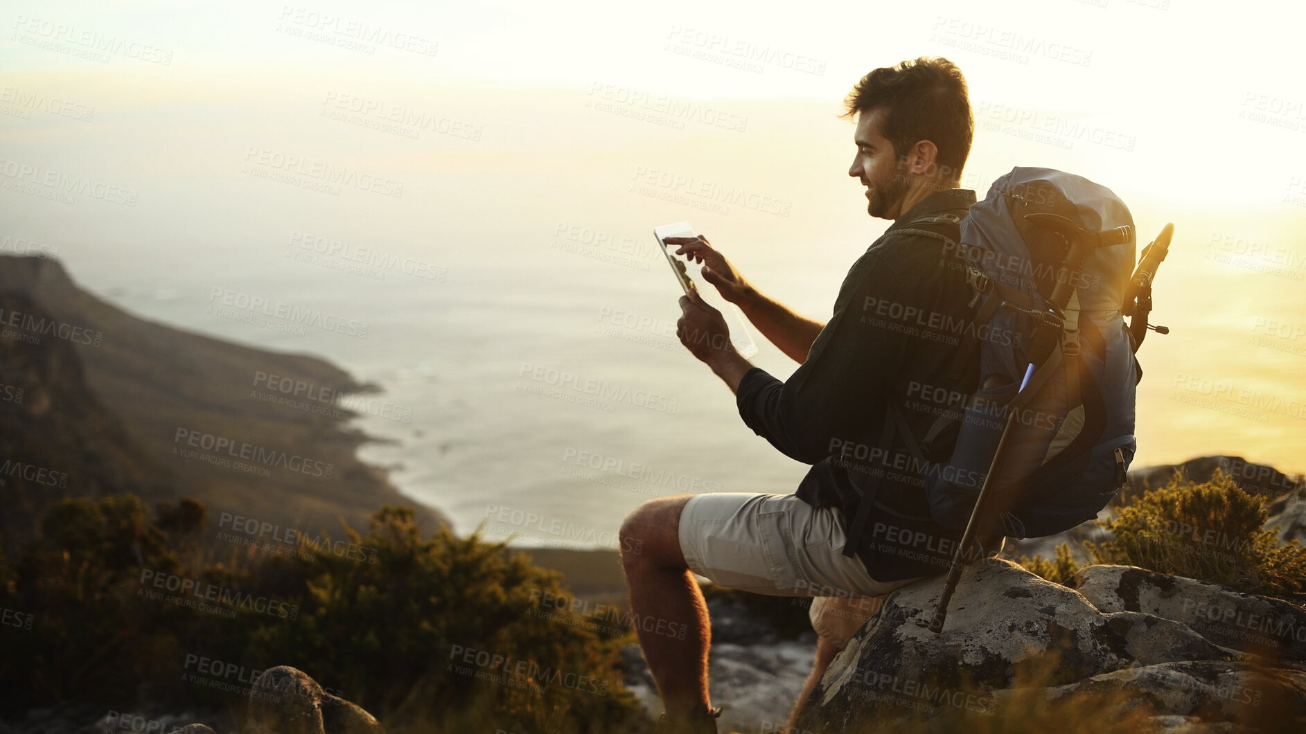Buy stock photo Man, hiking and search with tablet on mountain sunset or cliff for navigation app in nature. Male person, hiker or browsing with technology, backpack or equipment for trekking route or location