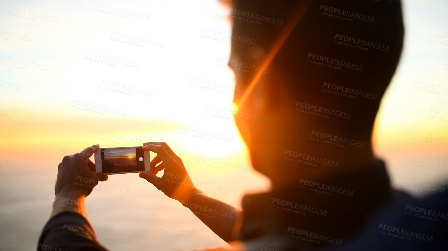 Buy stock photo Man, hands and phone screen with sunset for picture, photography or capture moment in nature. Male person, hiking or travel with mobile smartphone camera, app or lens flare for scenic view or memory