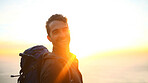 Hiking, sunrise and man with portrait outdoor for travel adventure, sightseeing or explore nature. Space, flare and person with backpack for trekking break, backpacker journey or happy at destination