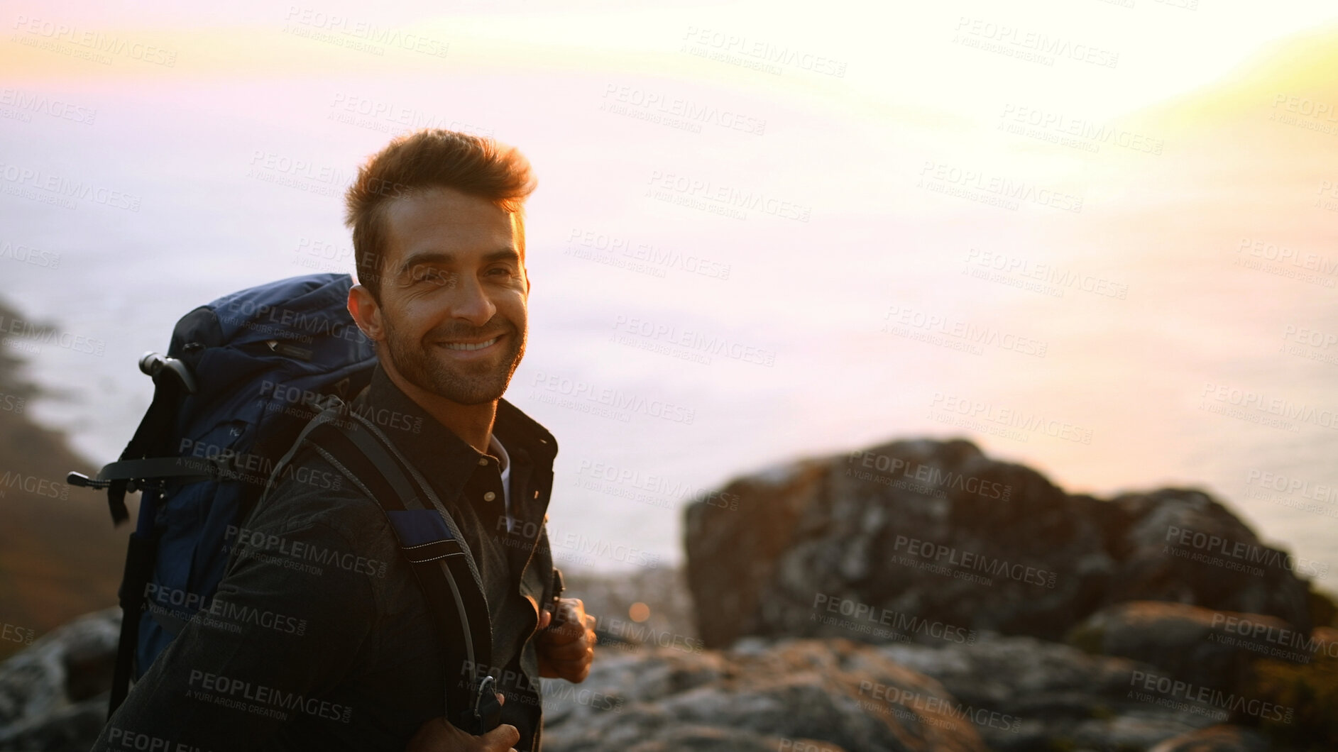 Buy stock photo Happy man, portrait or hiker on mountain sunset with backpack for outdoor adventure or journey. Male person, hiking or smile with bag or scenic view on cliff for trekking, fitness or travel on space