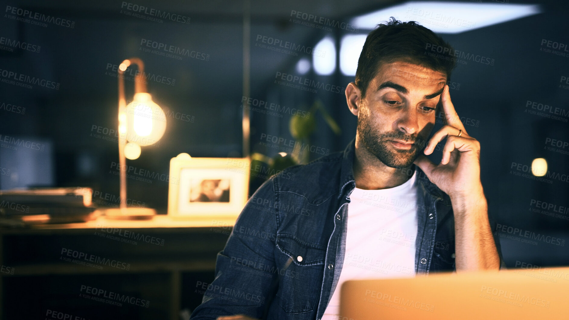 Buy stock photo Tired, employee and man with laptop, night and working late for web design, overworked and thinking. Burnout, brand designer and person with tech for deadline, contemplating and review of project