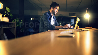 Buy stock photo Desk, laptop and night with business man in office for deadline or feedback on creative report. Computer, research and typing with design employee in dark workplace for productivity at zero hour
