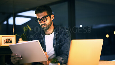 Buy stock photo Tablet, laptop and man in office at night with creative project with publishing online. Glasses, digital technology and magazine editor with computer for reading article, review deadline or workplace