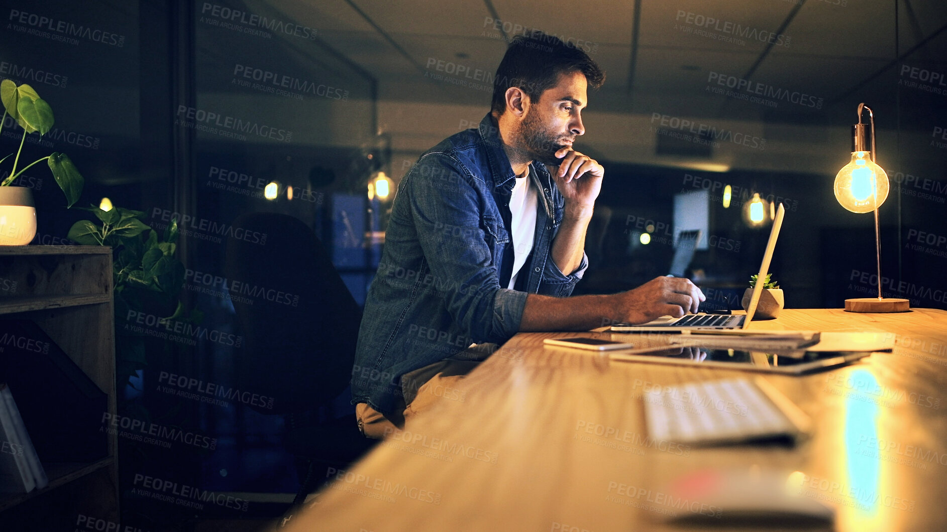 Buy stock photo Laptop, night and thinking with business man in office for deadline or feedback on creative report. Computer, problem solving and research with design employee at work for productivity in overtime