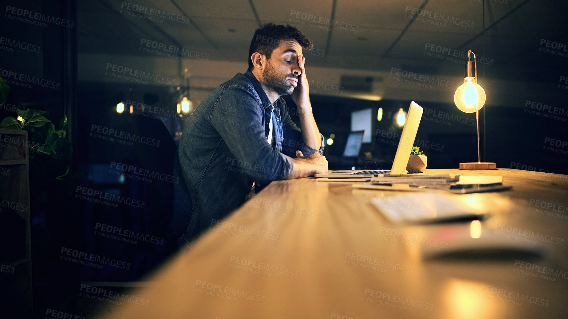 Buy stock photo Laptop, tired and business man in night office for research, copywriting deadline or project. Creative worker, writer or editor with fatigue, burnout or exhausted for editing news article online