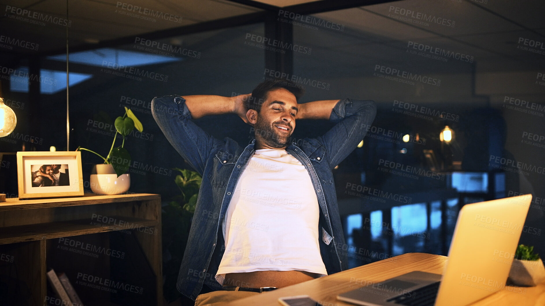 Buy stock photo Relax, night and man in office with laptop for finished project with deadline goal or achievement. Happy, stretching and male person with computer or completed easy task in workplace with overtime.
