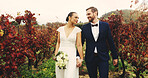 Bride, groom and happy couple holding hands at vineyard for love, marriage or walk at event. Wedding, man and woman at winery outdoor with flowers for romantic commitment, care or celebration on farm