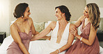Bride, bridesmaids and women laugh on wedding day with happiness, care and glamour on bed. Bridal party, hug and group of friends together for celebration, conversation and support in dressing room