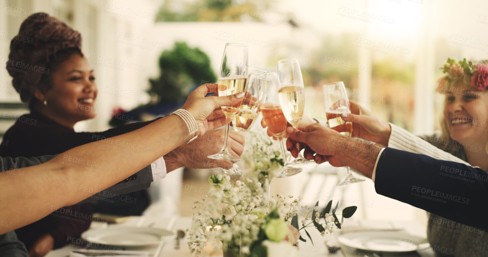 Buy stock photo Happy people, hands and cheers with champagne at table for wedding celebration or get together. Group, family and toast with glasses, drink or alcohol for fancy event, marriage dinner or connection