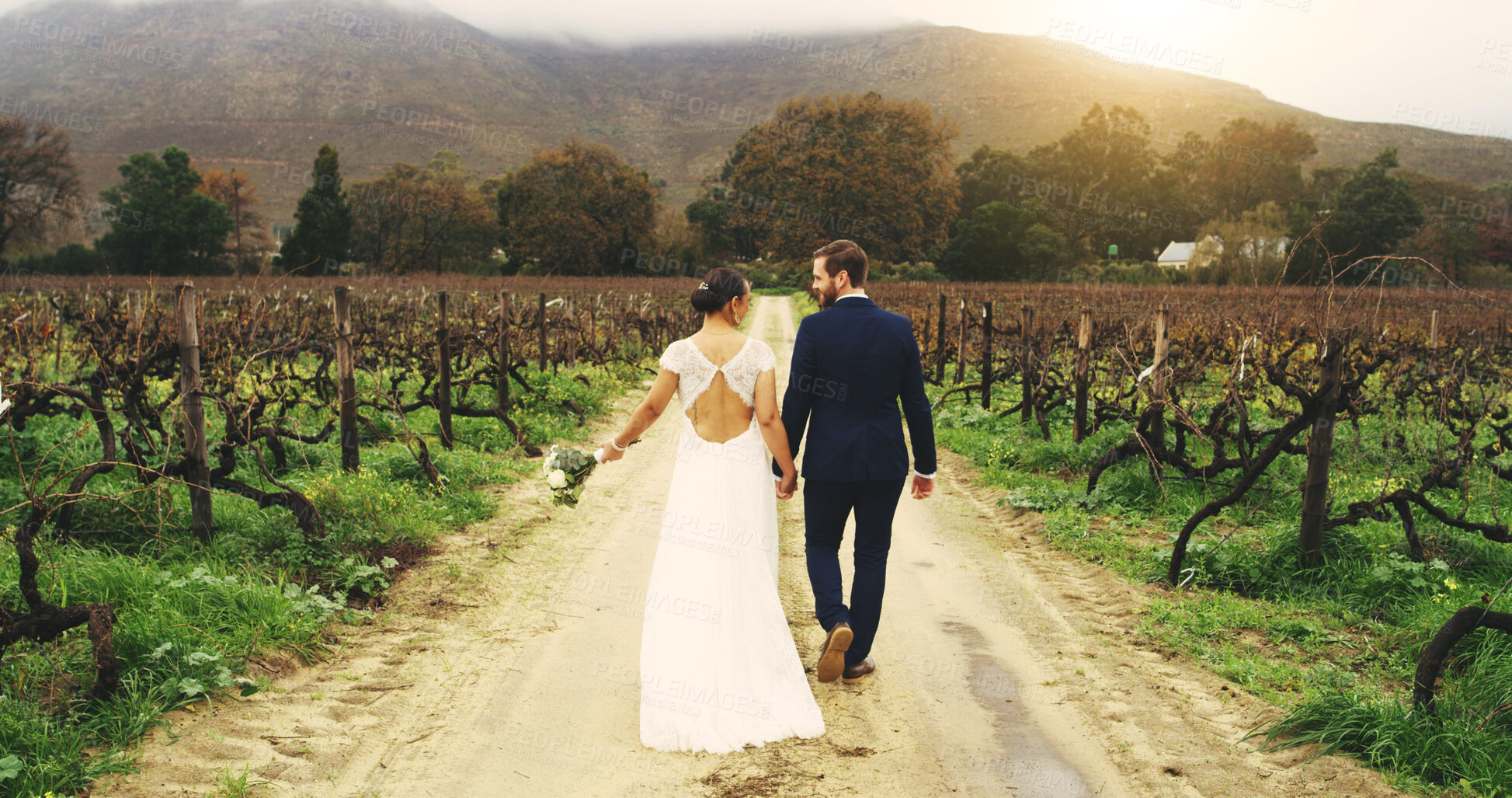 Buy stock photo Couple, vineyard and holding hands at wedding with back, love and floral bouquet on walk in nature. People, bride and groom with flowers, connection and loyalty with marriage event at farm in Italy