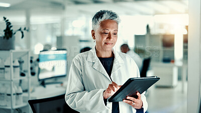 Buy stock photo Mature woman, scientist and tablet in lab for medical research, gene function and experiment. Person, digital and gmo editing for cell study, review report and virus information for vaccine results